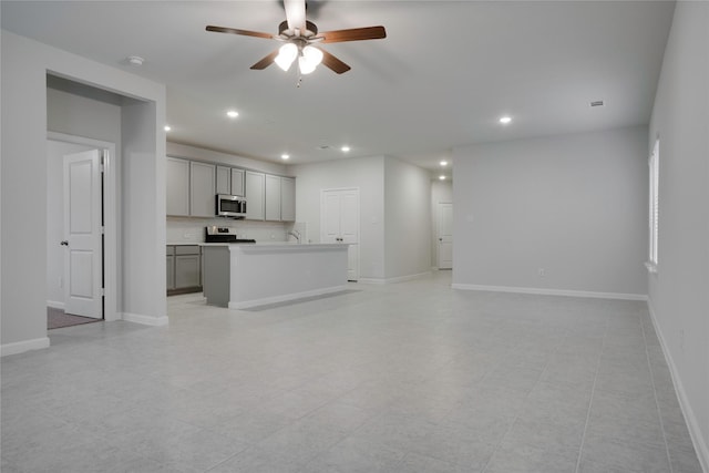 unfurnished living room with recessed lighting, baseboards, and a ceiling fan