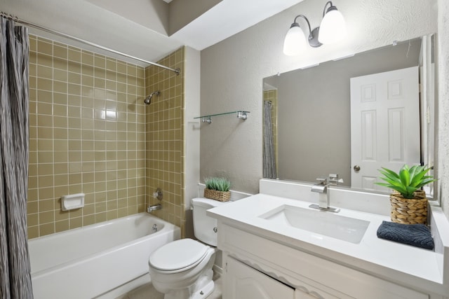 bathroom with a textured wall, vanity, shower / tub combination, and toilet