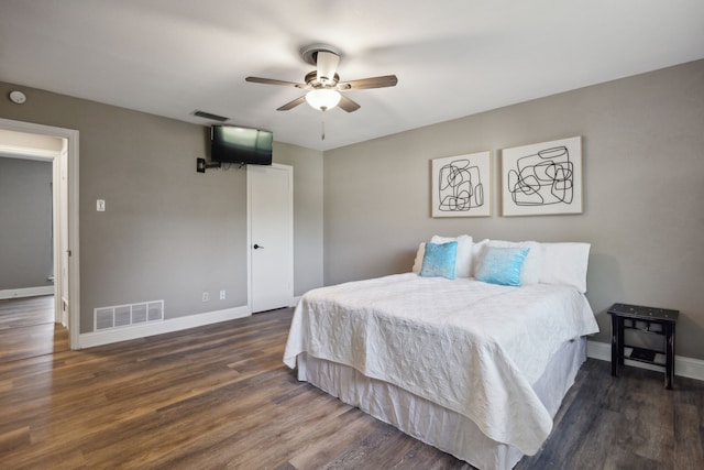 bedroom featuring visible vents, baseboards, a ceiling fan, and wood finished floors