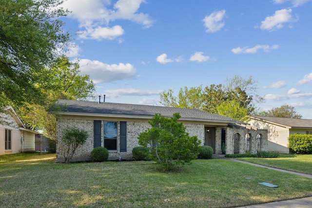 single story home with a front yard and brick siding