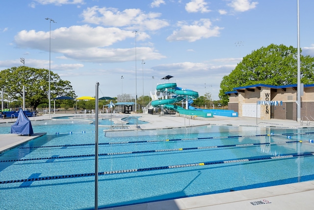 view of pool with a patio and a water slide