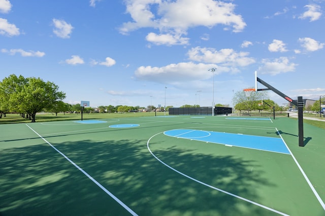 view of basketball court featuring fence and community basketball court