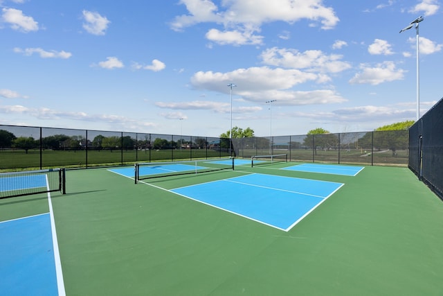 view of sport court featuring fence