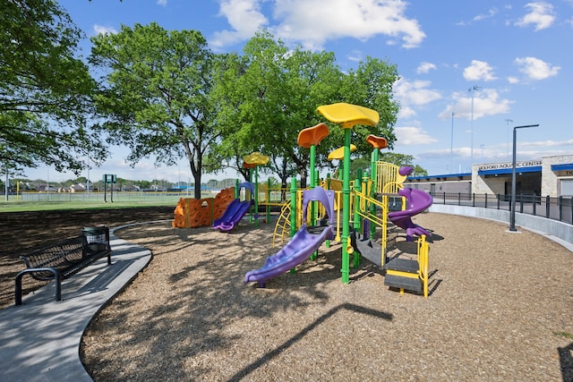 communal playground featuring fence
