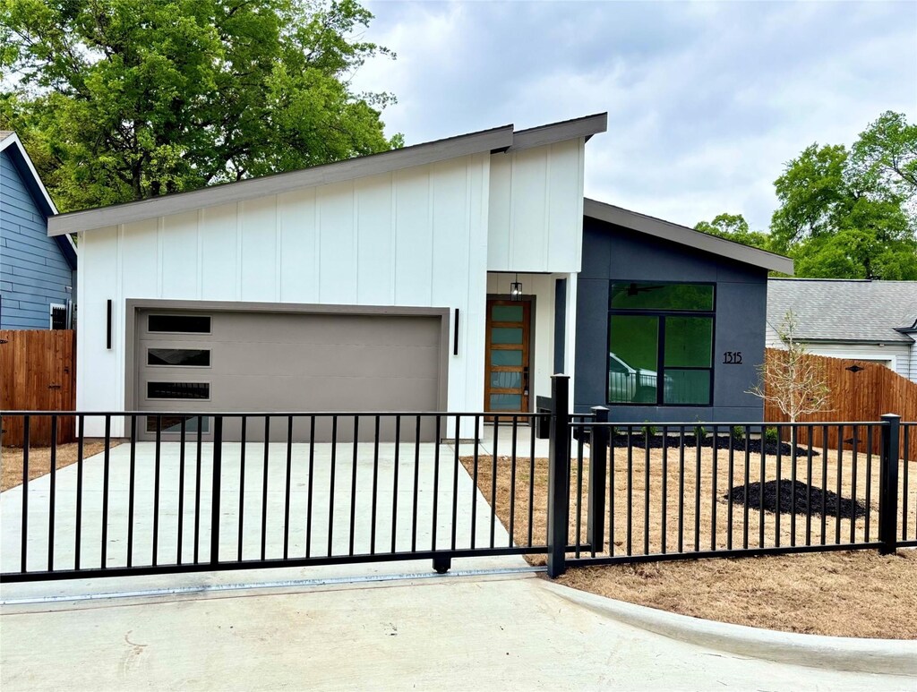 1315 Renner Dr, Dallas, TX 75216 - contemporary house featuring a fenced front yard and a garage