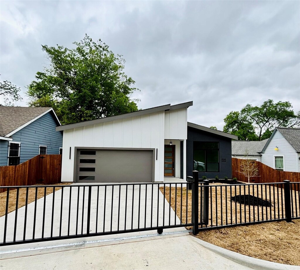 1315 Renner Dr, Dallas, TX 75216 - view of front of home with an attached garage, driveway, and a fenced front yard