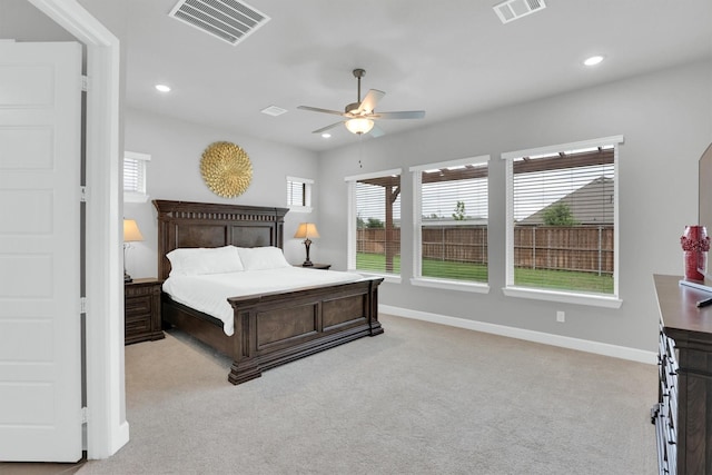 bedroom with multiple windows, light carpet, and visible vents