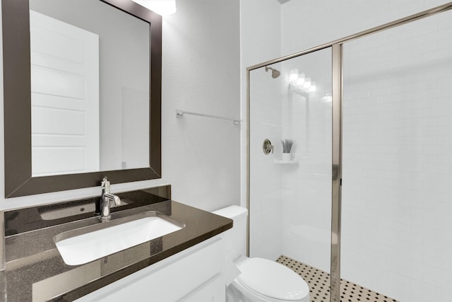 bathroom featuring a stall shower, vanity, and toilet