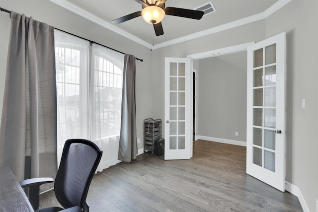 unfurnished office with wood finished floors, visible vents, french doors, and ornamental molding