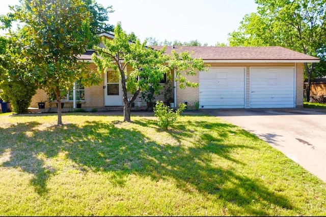 view of front of house featuring brick siding, a garage, a front yard, and concrete driveway