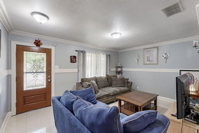 living area featuring ornamental molding, visible vents, and light tile patterned floors