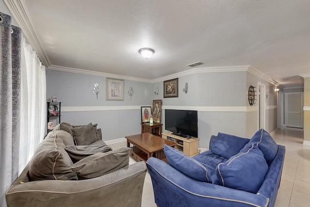 living room featuring light tile patterned floors, visible vents, and ornamental molding