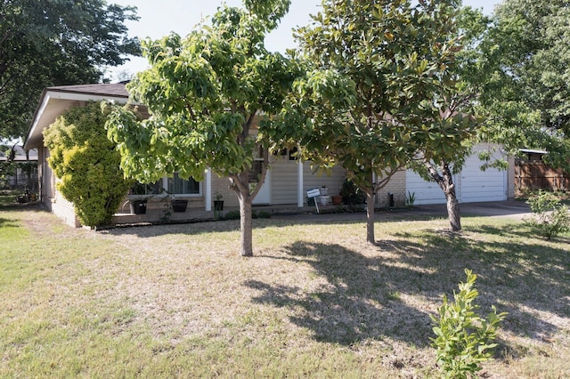 obstructed view of property featuring a front lawn and brick siding