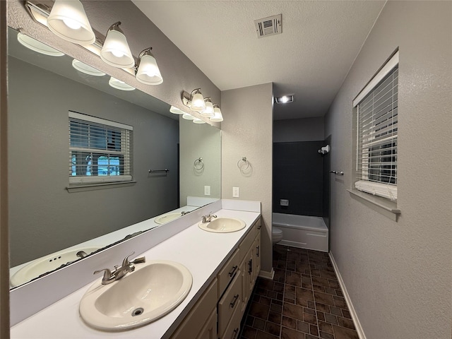 100 Russell St, Lorena, TX 76655 - bathroom with toilet, double vanity, baseboards, shower / washtub combination, and a textured ceiling