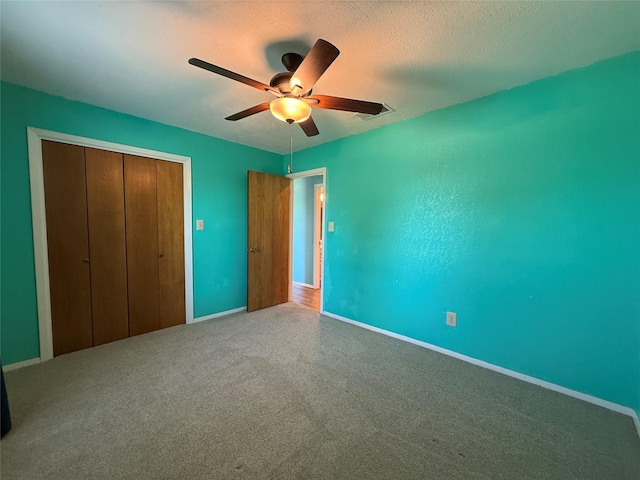 100 Russell St, Lorena, TX 76655 - unfurnished bedroom with a closet, carpet flooring, baseboards, ceiling fan, and a textured ceiling