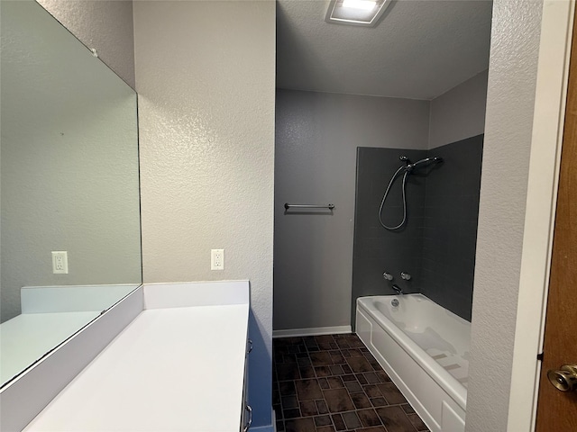 100 Russell St, Lorena, TX 76655 - bathroom featuring vanity, bathtub / shower combination, a textured wall, and baseboards