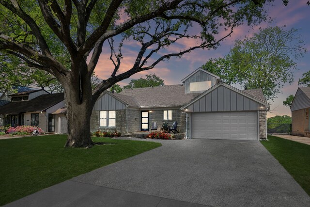 9431 Waterview Rd, Dallas, TX 75218 - view of front of property featuring board and batten siding, aphalt driveway, a garage, and a yard