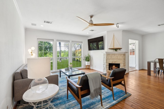 9431 Waterview Rd, Dallas, TX 75218 - living area featuring visible vents, a stone fireplace, and a ceiling fan
