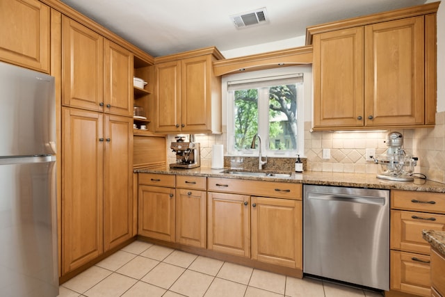9431 Waterview Rd, Dallas, TX 75218 - kitchen featuring visible vents, a sink, light stone countertops, decorative backsplash, and stainless steel appliances