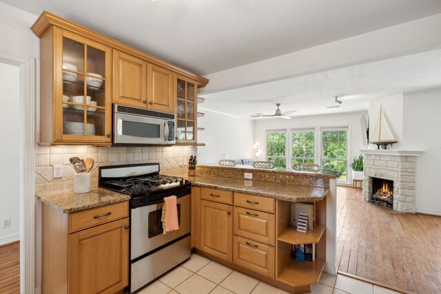 9431 Waterview Rd, Dallas, TX 75218 - kitchen featuring tasteful backsplash, a peninsula, open floor plan, open shelves, and appliances with stainless steel finishes