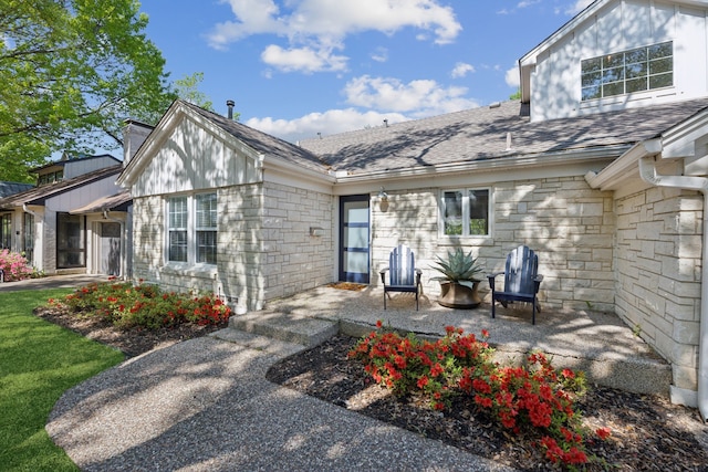 9431 Waterview Rd, Dallas, TX 75218 - exterior space with a patio area, roof with shingles, stone siding, and a chimney