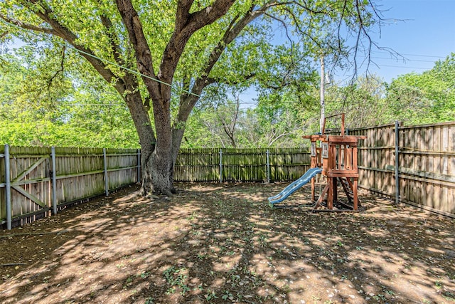 view of playground with a fenced backyard