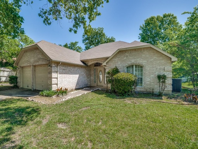 ranch-style house with a front yard, brick siding, and an attached garage