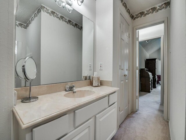 bathroom with vanity and a textured ceiling