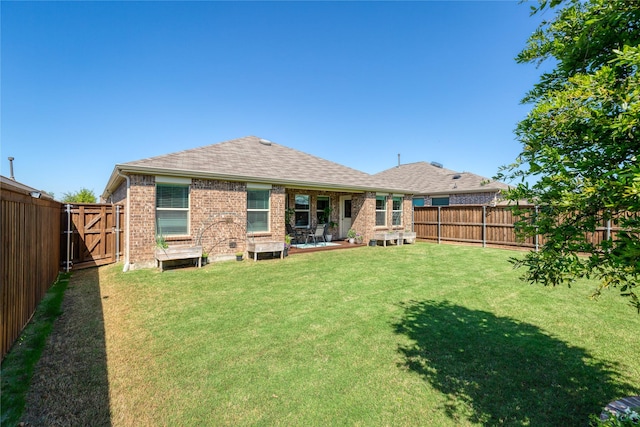 4512 Hiddenite Rd, Little Elm, TX 76227 - back of house with brick siding, a shingled roof, and a gate