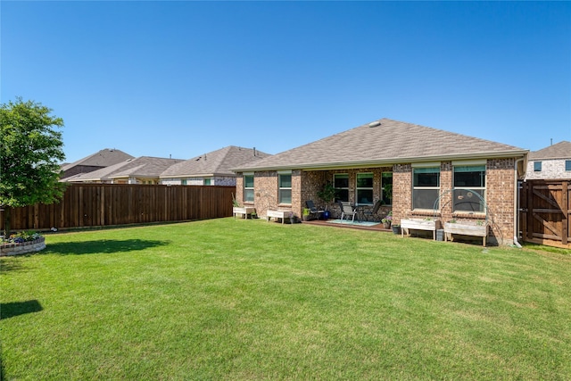 4512 Hiddenite Rd, Little Elm, TX 76227 - rear view of property featuring brick siding, a patio area, and roof with shingles