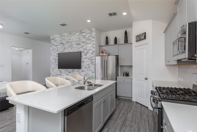 4512 Hiddenite Rd, Little Elm, TX 76227 - kitchen with stainless steel appliances, a sink, gray cabinets, decorative backsplash, and recessed lighting