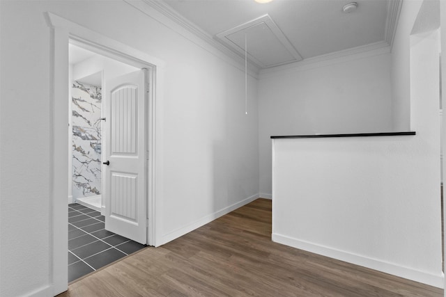 unfurnished room featuring crown molding, baseboards, attic access, and dark wood-style floors