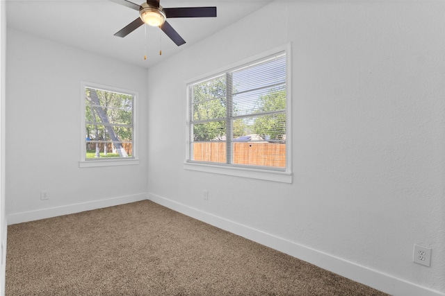empty room featuring carpet floors, baseboards, and ceiling fan