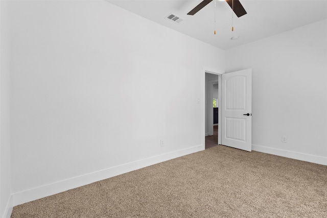 unfurnished room with a ceiling fan, baseboards, carpet, and visible vents