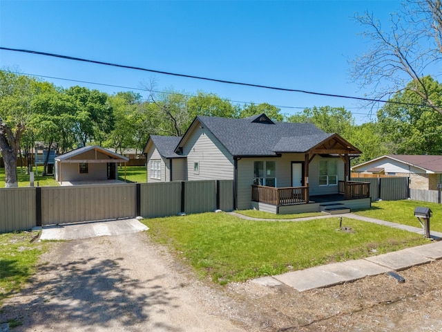 bungalow-style house featuring a front yard, a shingled roof, fence, a gate, and driveway