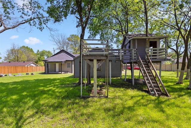 view of jungle gym with a yard and fence
