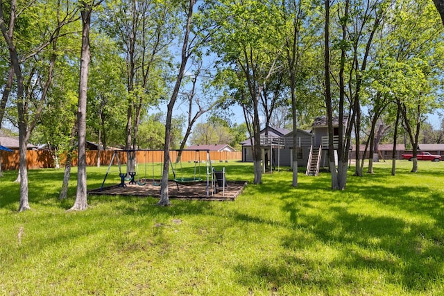 view of yard with a fenced backyard and stairway