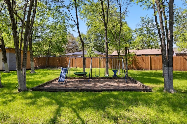 view of playground with a yard and a fenced backyard