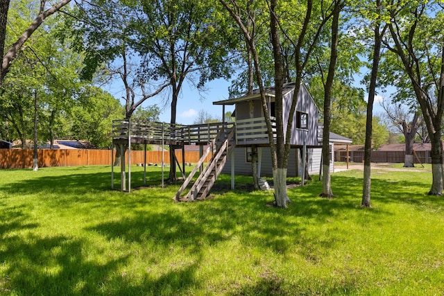exterior space with a fenced backyard and stairway