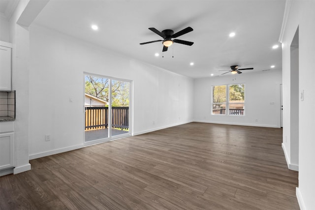 unfurnished living room featuring dark wood-type flooring, a ceiling fan, and recessed lighting