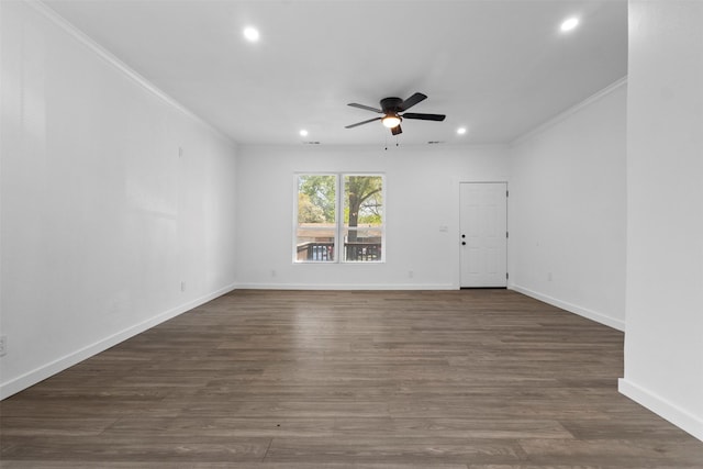 empty room with dark wood-type flooring, crown molding, and a ceiling fan
