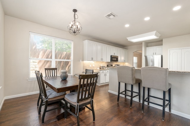 3733 Glassenberry St, Fort Worth, TX 76244 - dining space featuring baseboards, recessed lighting, dark wood-style floors, visible vents, and arched walkways