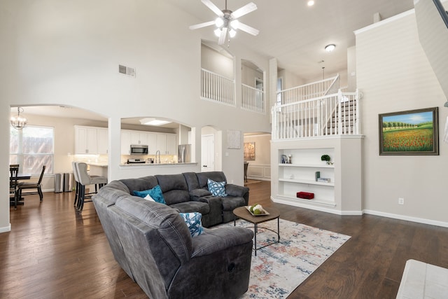 3733 Glassenberry St, Fort Worth, TX 76244 - living area with baseboards, dark wood-type flooring, visible vents, arched walkways, and ceiling fan with notable chandelier