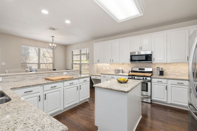 3733 Glassenberry St, Fort Worth, TX 76244 - kitchen with white cabinets, appliances with stainless steel finishes, backsplash, and visible vents