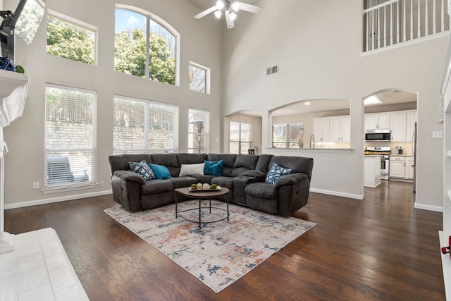 3733 Glassenberry St, Fort Worth, TX 76244 - living area featuring arched walkways, ceiling fan, baseboards, and dark wood-style floors