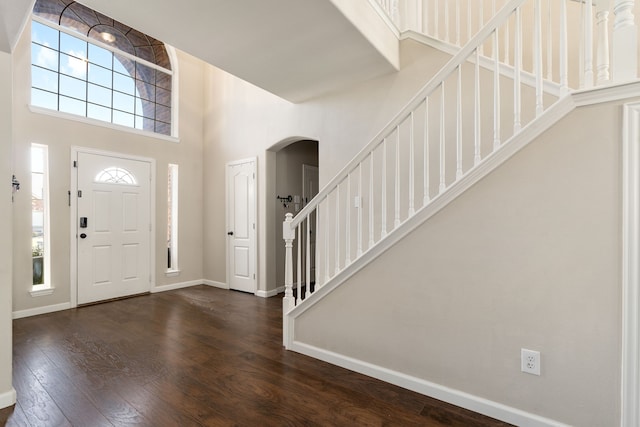 3733 Glassenberry St, Fort Worth, TX 76244 - foyer entrance featuring arched walkways, a towering ceiling, baseboards, and dark wood finished floors