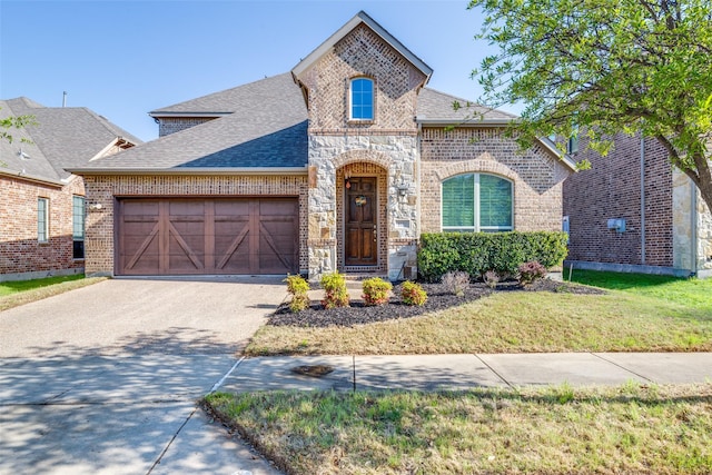 5101 Joseph St, Lewisville, TX 75056 - french country style house featuring brick siding, driveway, roof with shingles, an attached garage, and stone siding