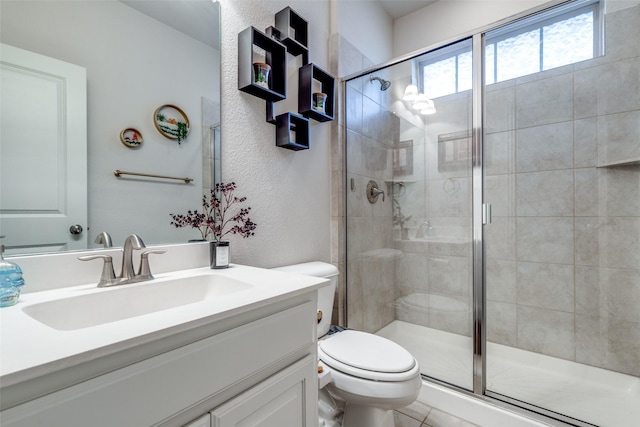 5101 Joseph St, Lewisville, TX 75056 - bathroom with toilet, a shower stall, vanity, and a textured wall