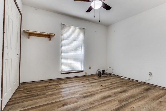 spare room with a ceiling fan and wood finished floors