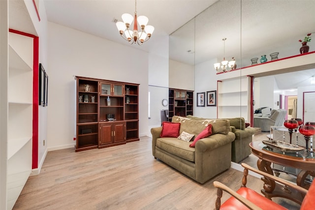 1128 Germany Dr, Cedar Hill, TX 75104 - living room featuring a chandelier, light wood finished floors, a high ceiling, and baseboards